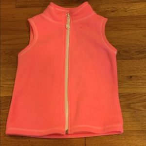 A pinkish-orangeish soft vest.